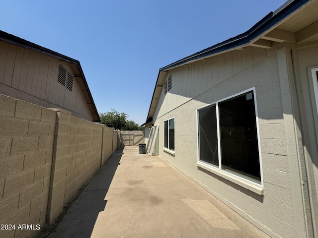 view of side of property with a patio area