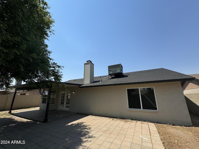 back of house with central AC unit, a patio area, and french doors