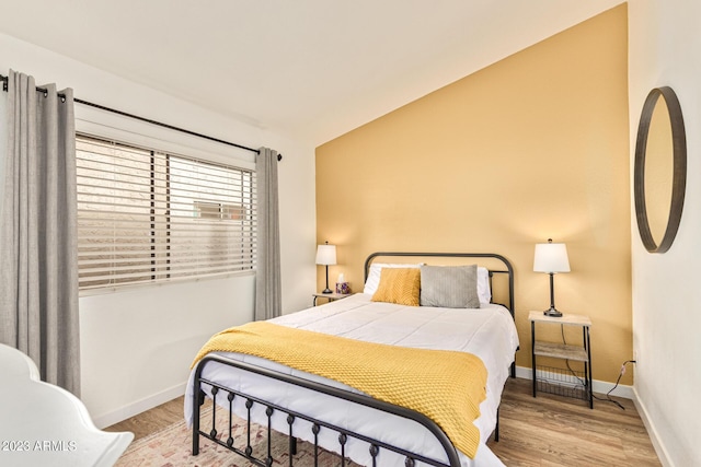 bedroom with wood finished floors and baseboards