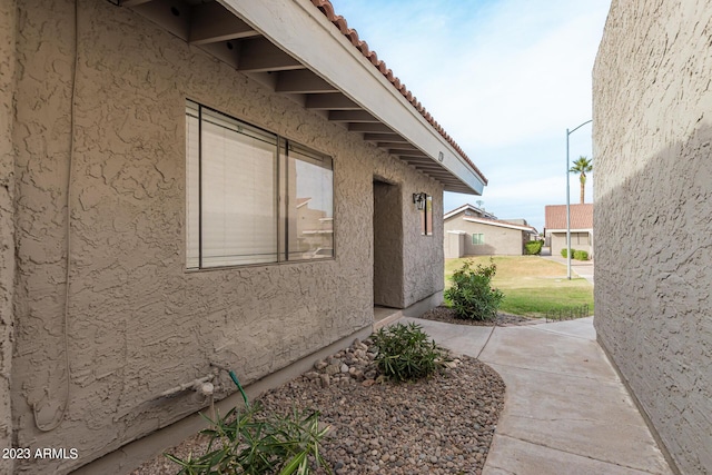 view of property exterior featuring a tiled roof and stucco siding