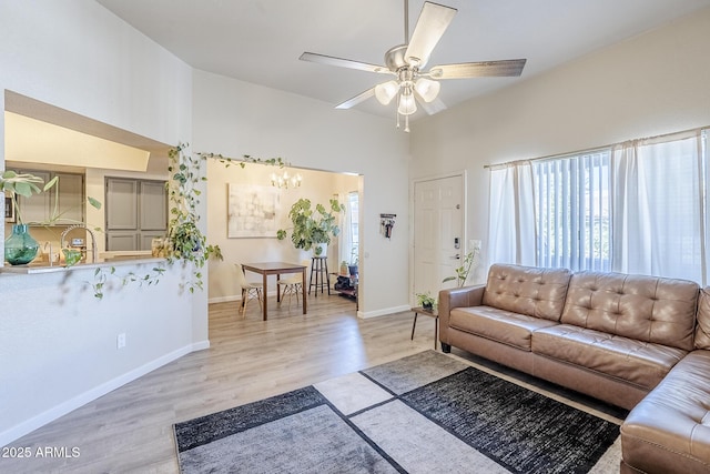 1331 W Baseline Rd Unit 360, Mesa, AZ 85202 - living area with light wood-type flooring, ceiling fan, and a chandelier