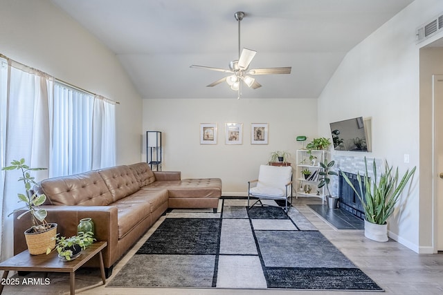1331 W Baseline Rd Unit 360, Mesa, AZ 85202 - living room with lofted ceiling, ceiling fan, wood finished floors, and a tile fireplace