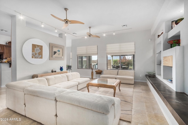 tiled living room with ceiling fan and rail lighting