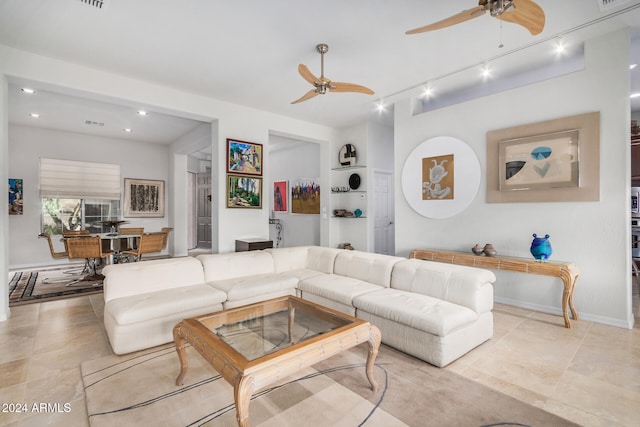 living room with built in features, light tile patterned floors, and track lighting