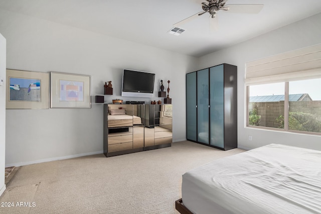 bedroom featuring ceiling fan and light carpet