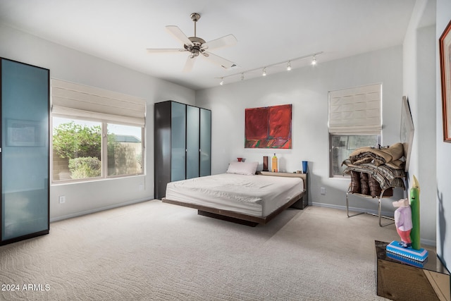 bedroom with ceiling fan and light colored carpet