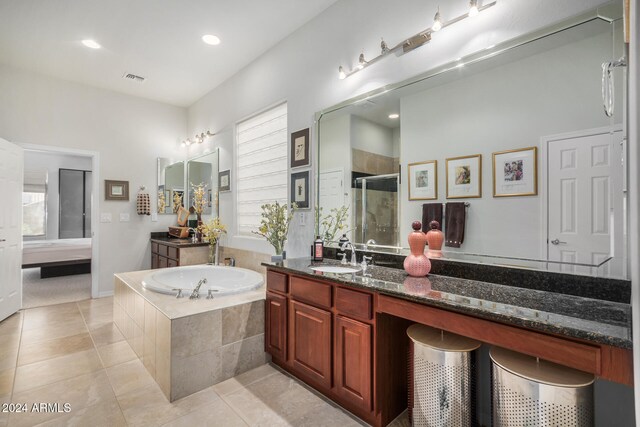 bathroom with plus walk in shower, vanity, and tile patterned floors