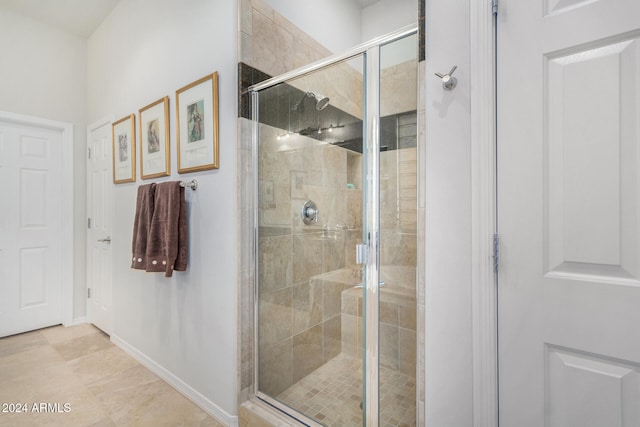 bathroom with tile patterned flooring and walk in shower