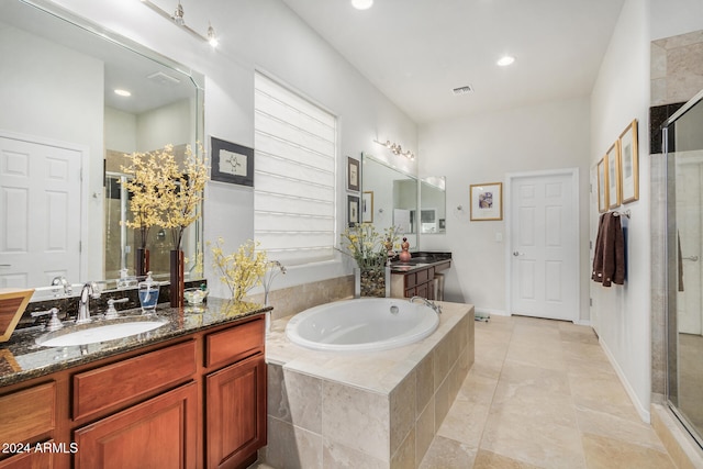 bathroom featuring tile patterned flooring, vanity, and shower with separate bathtub