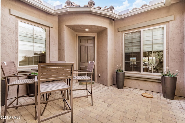 view of exterior entry featuring a patio area