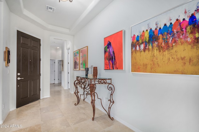 entryway with a raised ceiling