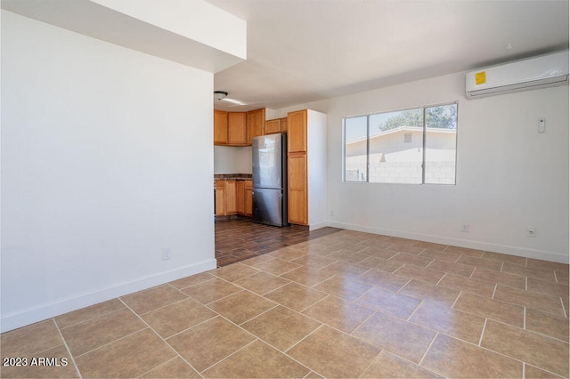 unfurnished living room with a wall mounted AC and light tile floors