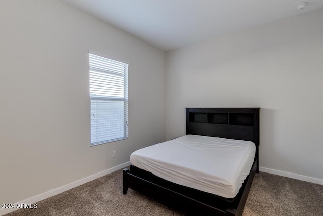 carpeted bedroom featuring baseboards