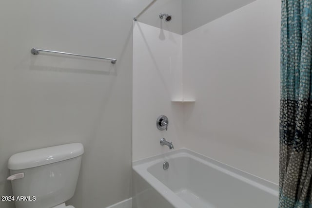 full bathroom featuring shower / bathtub combination with curtain and toilet