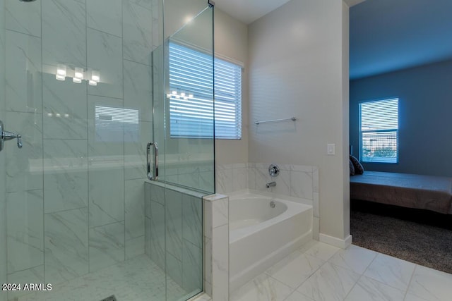 bathroom featuring a wealth of natural light, a garden tub, marble finish floor, and a shower stall