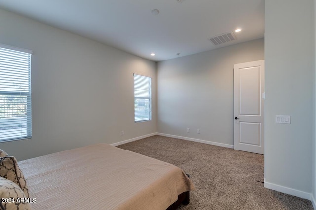 carpeted bedroom featuring recessed lighting, visible vents, and baseboards