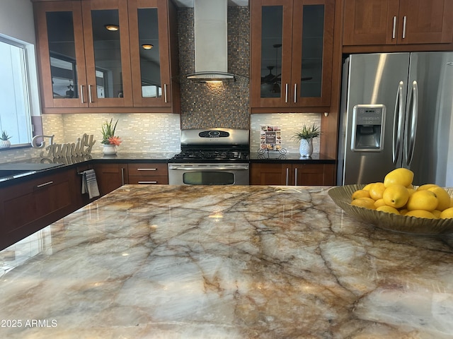 5802 E Spring Rd, Scottsdale, AZ 85254 - kitchen featuring stainless steel appliances, wall chimney exhaust hood, decorative backsplash, and glass insert cabinets