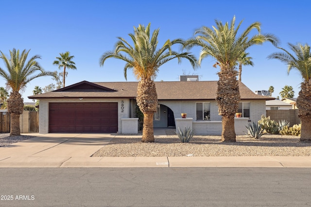 5802 E Spring Rd, Scottsdale, AZ 85254 - ranch-style home with an attached garage, fence, concrete driveway, and brick siding