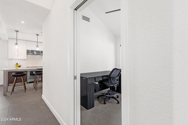 office featuring tile floors and vaulted ceiling