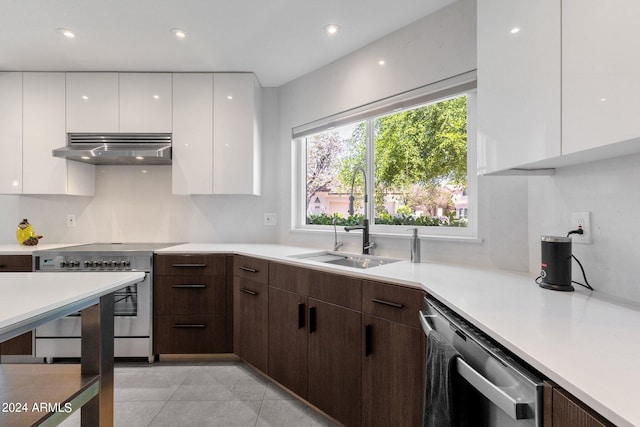 kitchen with wall chimney range hood, stainless steel appliances, sink, and white cabinetry