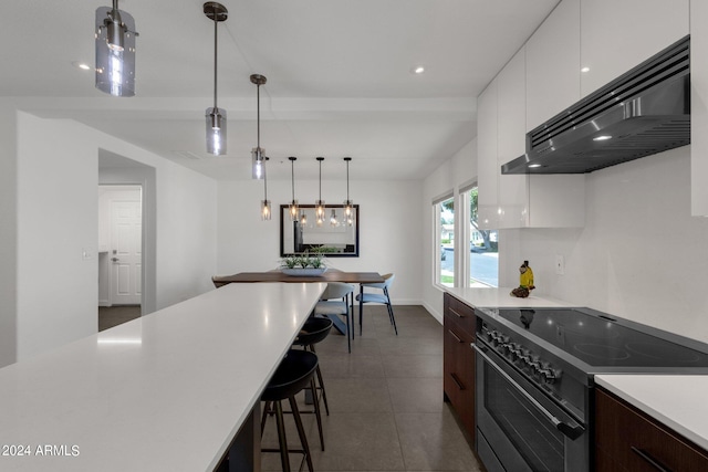 kitchen with white cabinetry, dark brown cabinets, electric range oven, pendant lighting, and dark tile flooring