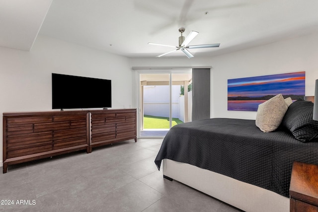 tiled bedroom with ceiling fan and access to outside