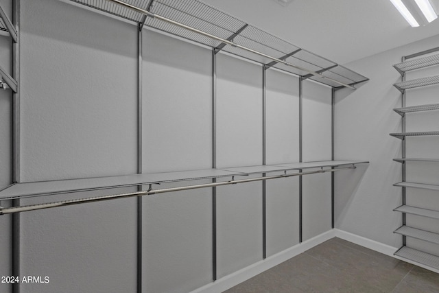 spacious closet featuring tile flooring