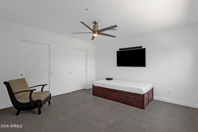 interior space with ceiling fan and a closet