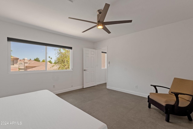 tiled bedroom featuring ceiling fan