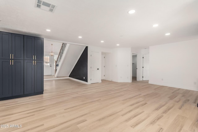 interior space with light wood finished floors, stairs, visible vents, and recessed lighting