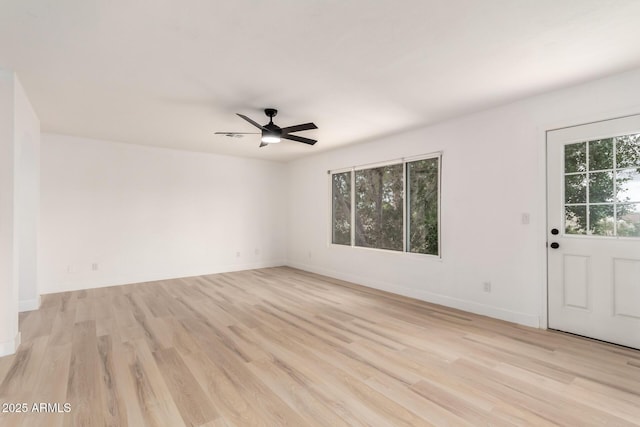 unfurnished room with a ceiling fan, light wood-style flooring, and baseboards