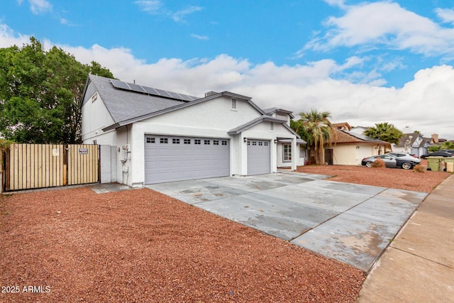 single story home with a garage, fence, concrete driveway, a gate, and stucco siding