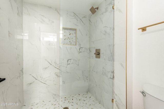 full bathroom with a marble finish shower and toilet