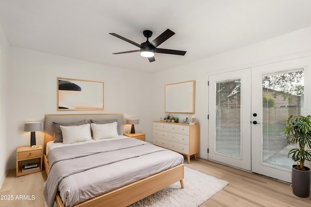 bedroom with access to exterior, light wood-type flooring, french doors, and a ceiling fan