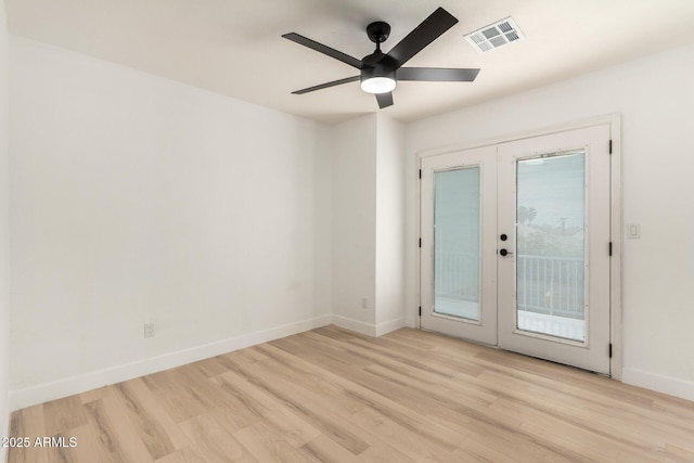 unfurnished room with french doors, visible vents, ceiling fan, wood finished floors, and baseboards