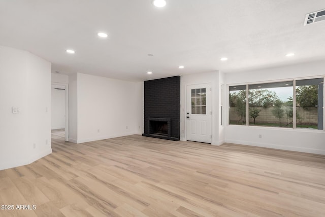 unfurnished living room featuring light wood-style floors, visible vents, and recessed lighting