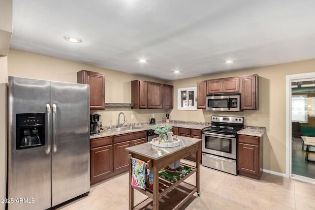 3643 E Friess Dr, Phoenix, AZ 85032 - kitchen with appliances with stainless steel finishes, a sink, light tile patterned flooring, recessed lighting, and baseboards