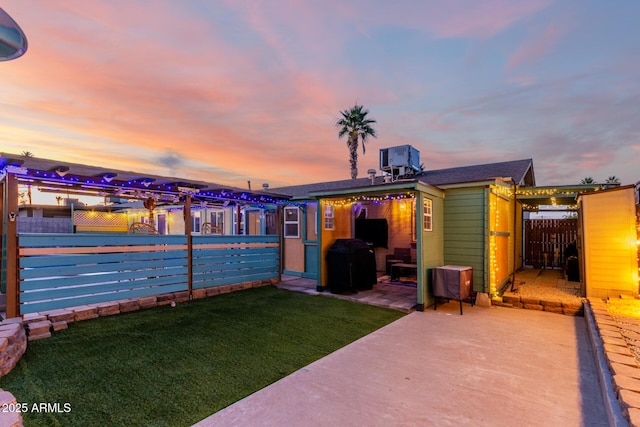 3643 E Friess Dr, Phoenix, AZ 85032 - yard at dusk with a patio, central AC, and an outdoor structure