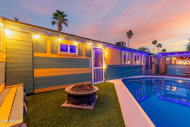 3643 E Friess Dr, Phoenix, AZ 85032 - pool at dusk featuring a fire pit and an outdoor pool