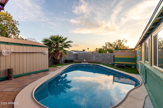 3643 E Friess Dr, Phoenix, AZ 85032 - pool at dusk with a fenced backyard and a patio