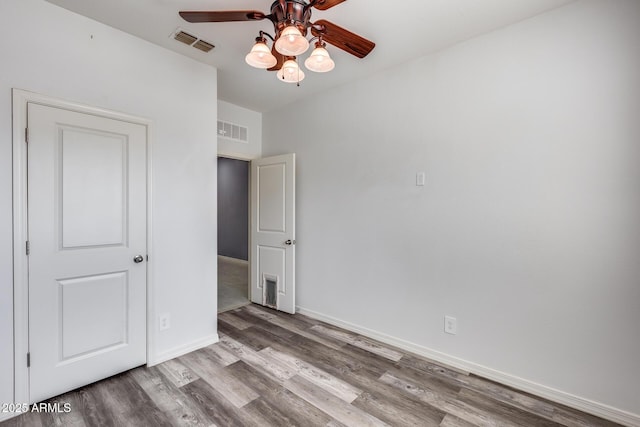 unfurnished bedroom with ceiling fan and light hardwood / wood-style floors