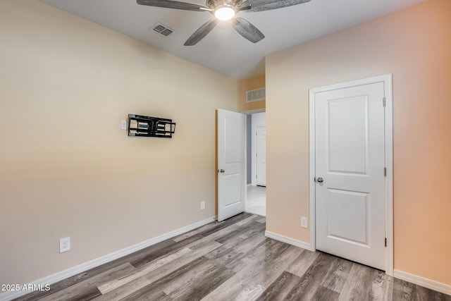 unfurnished bedroom with hardwood / wood-style floors and ceiling fan