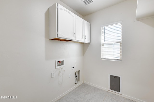 washroom featuring cabinets, gas dryer hookup, electric dryer hookup, and hookup for a washing machine