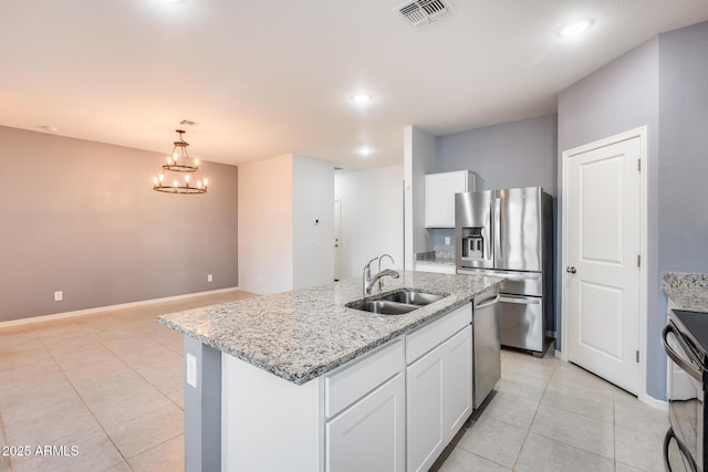 kitchen with white cabinetry, stainless steel appliances, a kitchen island with sink, and sink