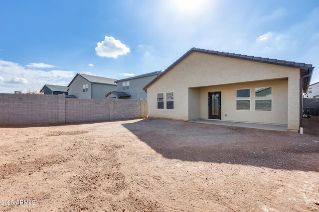 rear view of property featuring a patio