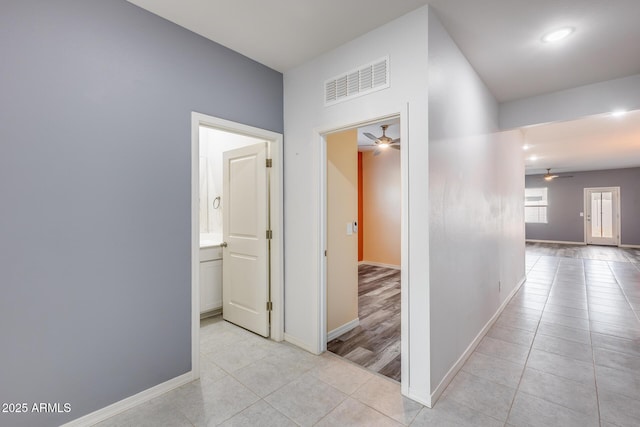 corridor featuring light tile patterned floors