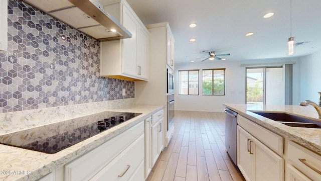 kitchen with ceiling fan, recessed lighting, a sink, appliances with stainless steel finishes, and backsplash