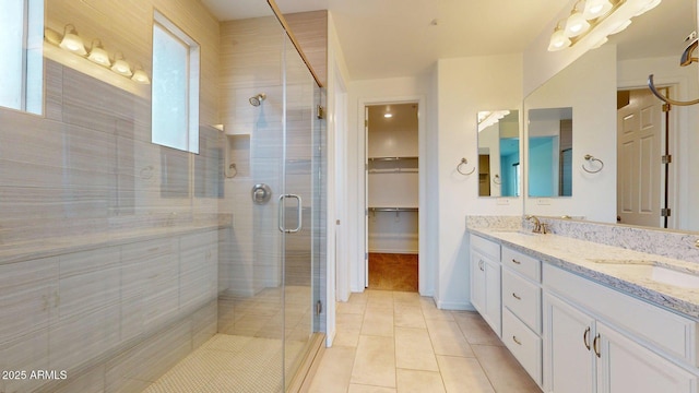 full bath featuring a sink, tile patterned floors, and a healthy amount of sunlight