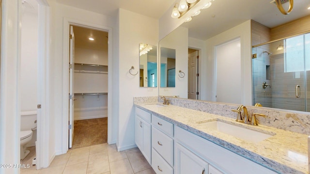 full bathroom with a sink, tile patterned flooring, a stall shower, and toilet