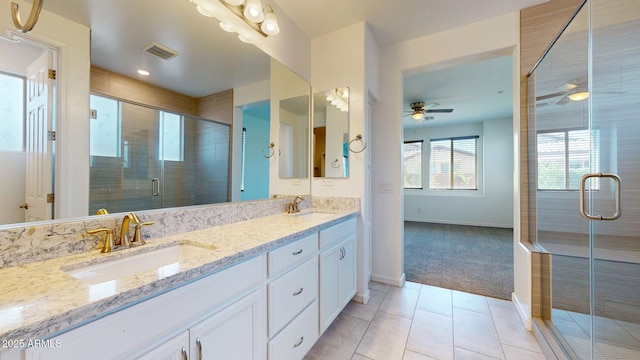 bathroom featuring a sink, tile patterned floors, baseboards, and visible vents